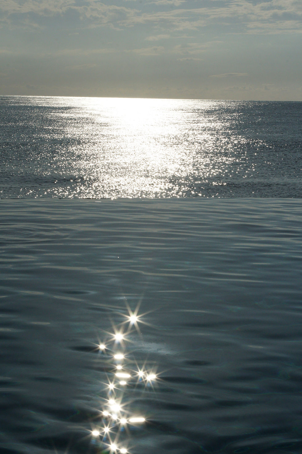 Reflective turquoise ocean water on a beach in Jamaica.