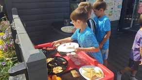 Kids help themselves to fresh food outdoors.