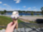 Someone holding an ice cream cone facing Sylvan Lake at Sundaes on Sylvan in Rome City Indiana