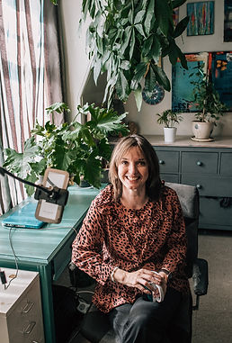 Brand Photograph of a female business owner in her office smiling at the camera