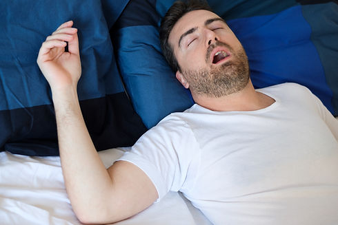 Man in bed suffering for sleep apnea syndrome.jpg
