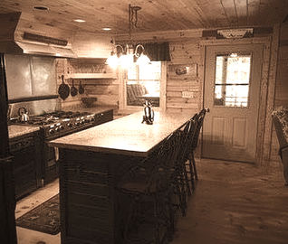 Island, stove and pine wood floors and wall in REW Lake Rentals vacation rental in Denmark Maine