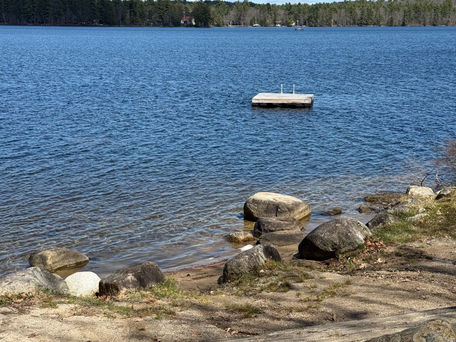 Moose Pond waterfront with dock in the vacation rental by REW Lake Rentals