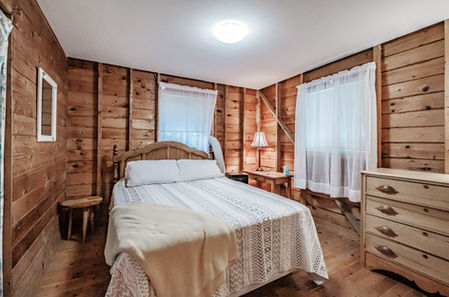 Queen bedroom off the main living area of Long Lake vacation rental