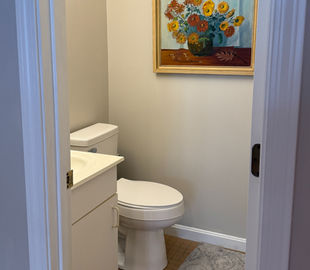 Half bathroom off the entry with toiled and sink in Fireside Retreat vacation rental