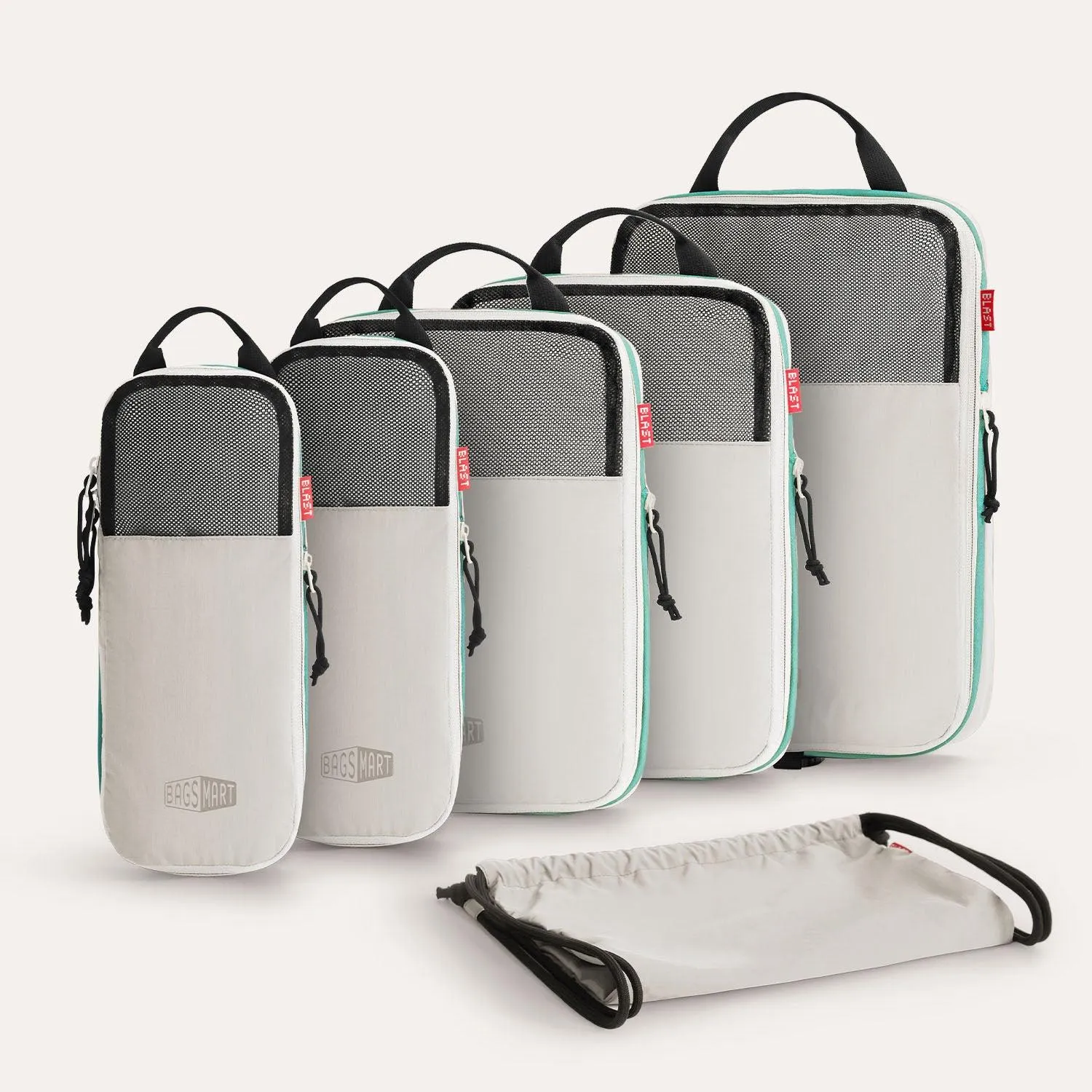 Set of BAGSMART compression packing cubes in various sizes neatly arranged on a bed.