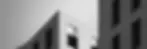 Black and white photo of angular commercial building exterior corner