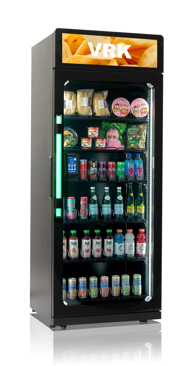 Tall single-door smart cooler with a lit door handle, stocked with drinks and snacks