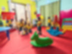 preschool play area with colorful seating and spinning play equipment