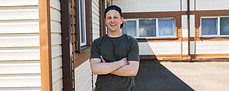 smiling-man-in-casual-wear-standing-outside-a-mode-2026-06-25-18-19-33-utc.jpg
