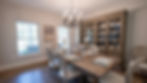 Modern dining room with wooden table and large hutch.