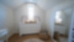 White dresser and full-length mirror in a bright bedroom