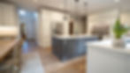 Modern kitchen with grey island and white cabinets
