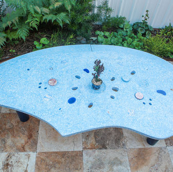 baby blue contemporary terrazzo concrete dining table in a tear drop shape 