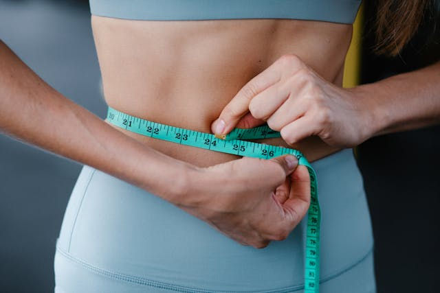 A person measuring her waist