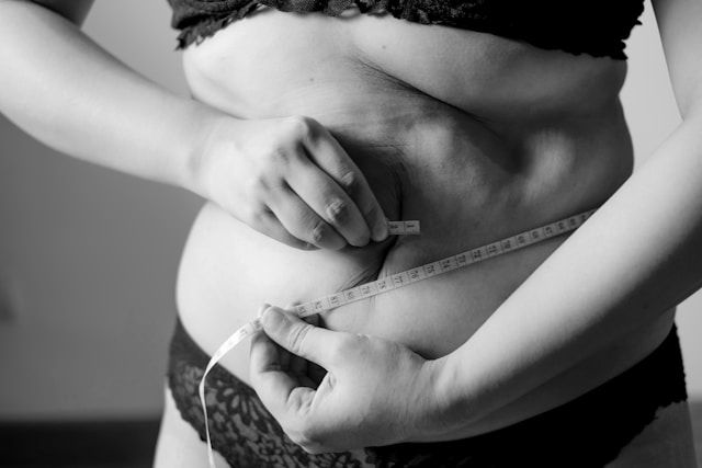 Person measuring their waist