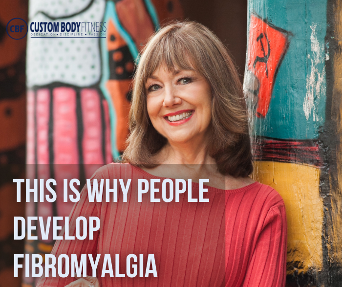 Smiling woman in red stands by colorful graffiti wall; text reads This is why people develop fibromyalgia and Custom Body Fitness