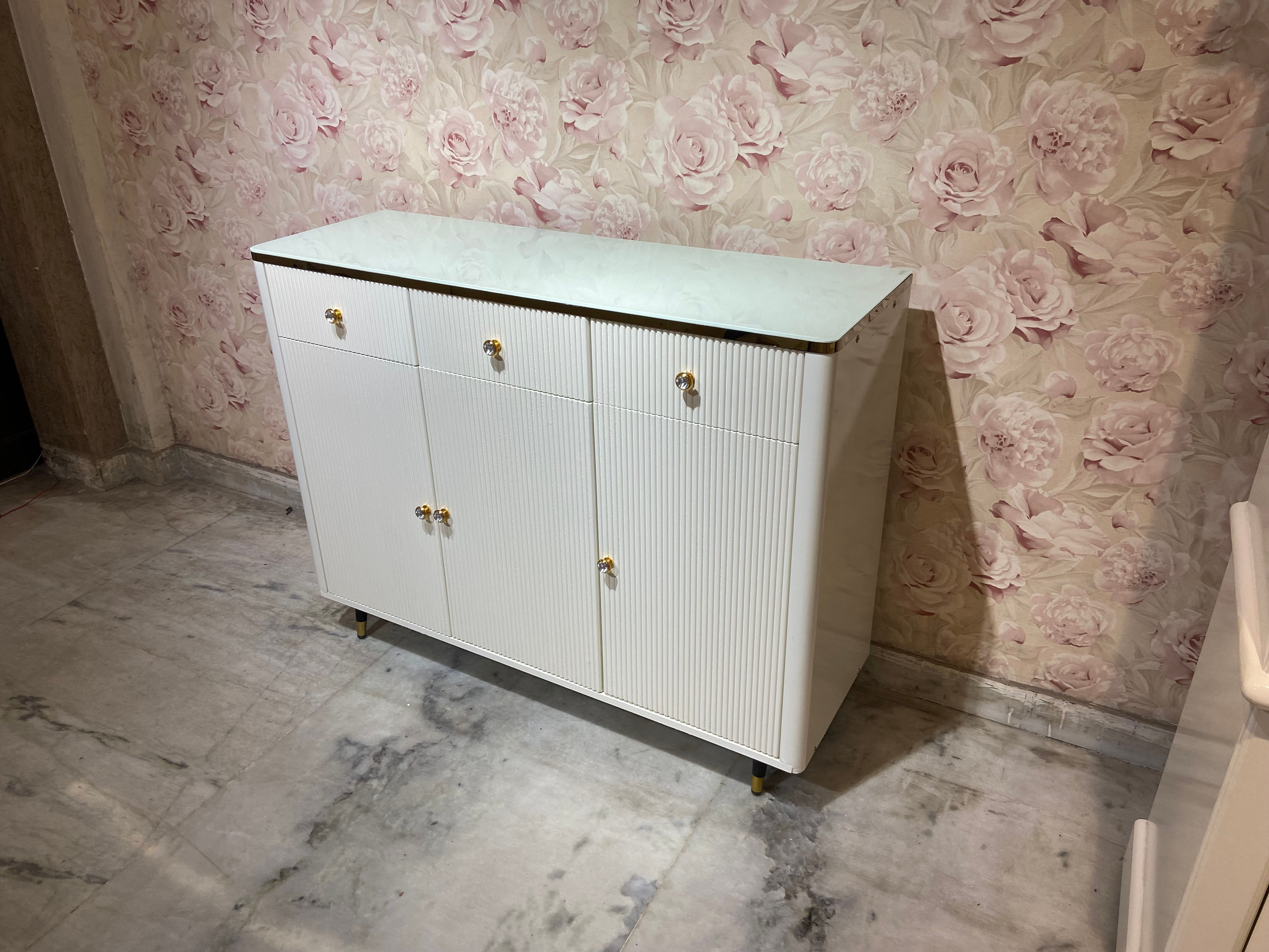 4-feet cabinet with a sleek ivory polish finish & a captivating ivory glass top