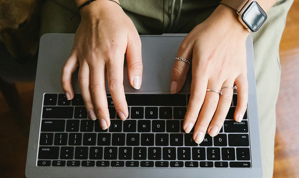 Aerial view of a copywriter typing on laptop