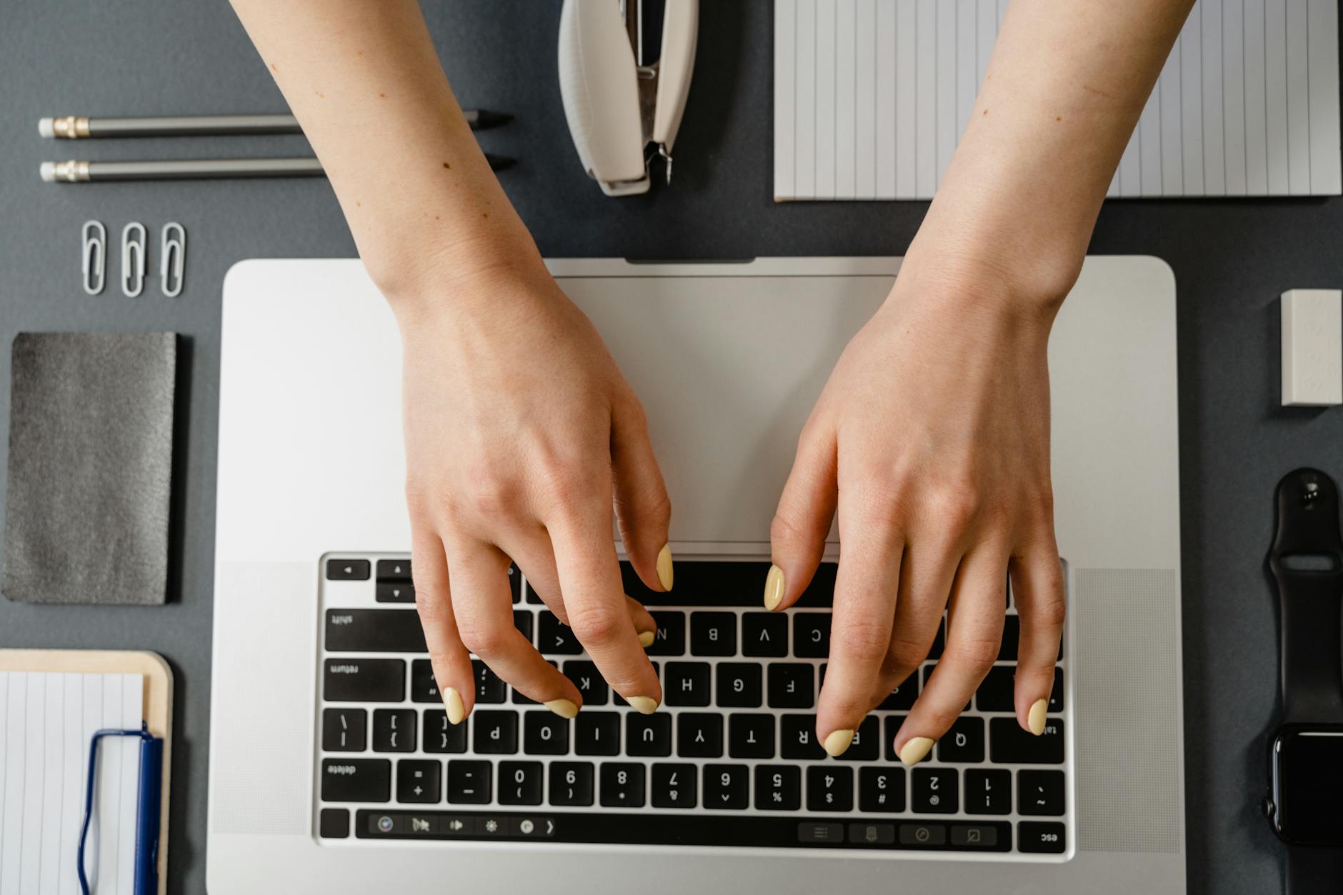 a close up shot of a person typing on a laptop