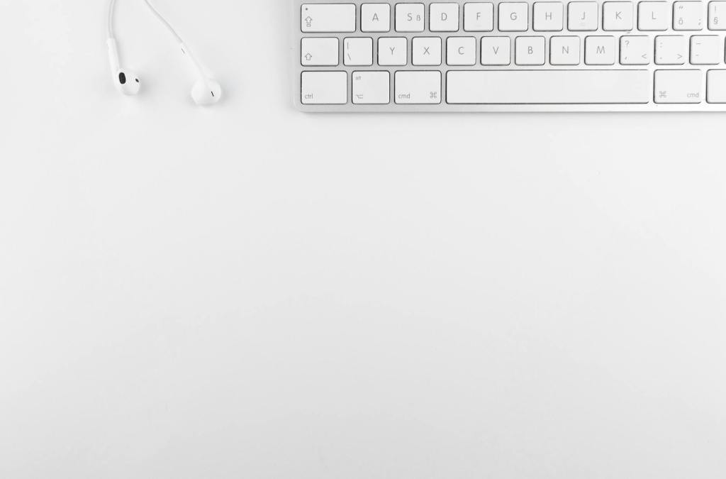 top view photo of keyboard near earphones