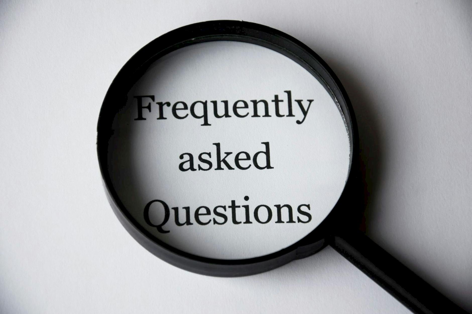 black magnifying glass over the words "Frequently Asked Questions"