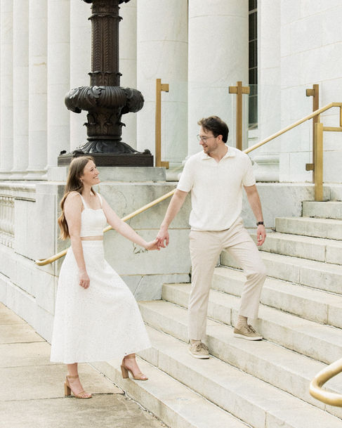 Romantic engaged couple embracing on quaint street in downtown Birmingham, Alabama.