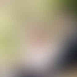 Bride softly wiping her tears as the groom reads heartfelt wedding vows