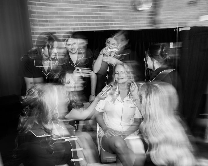 Bride surrounded by bridesmaids getting makeup applied at Lumberyard in Huntsville Alabama