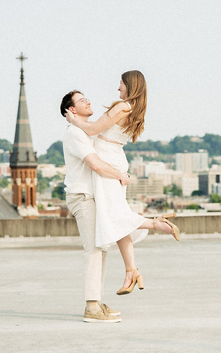 Happy engaged couple hugging  for  portrait on rooftop in Birmingham, Alabama