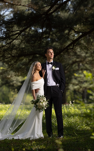 bride and groom posing for portrait in White Barn at Padgett Place 