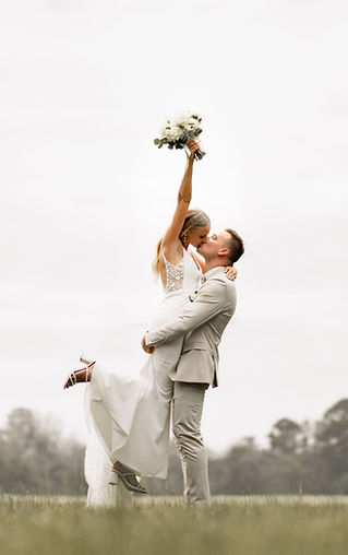 Groom holding bride in her arm celebrating there wedding