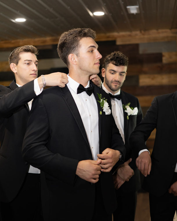 groom getting ready in white barn at Padgett place in Huntsville Alabama