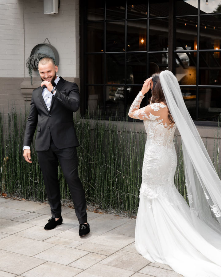 groom seeing his bride for the first time during first look.
