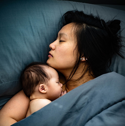 Baby photo sleeping with mom.