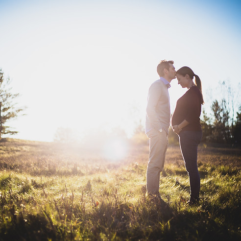 Maternity Photo - Father and Mother in a sunny meadow