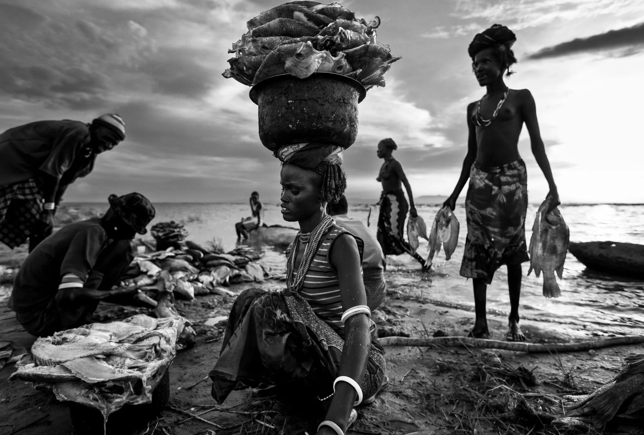 Daasanach families sort freshly caught fish on the shores of Lake Turkana