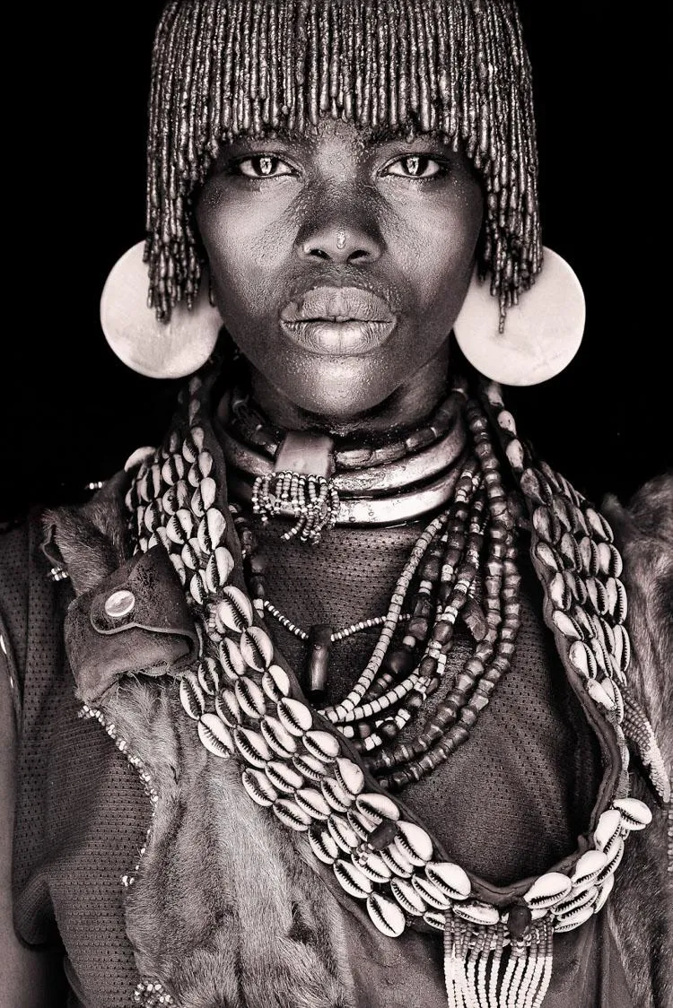 A Hamar woman wearing traditional shell necklaces, metal neck rings
