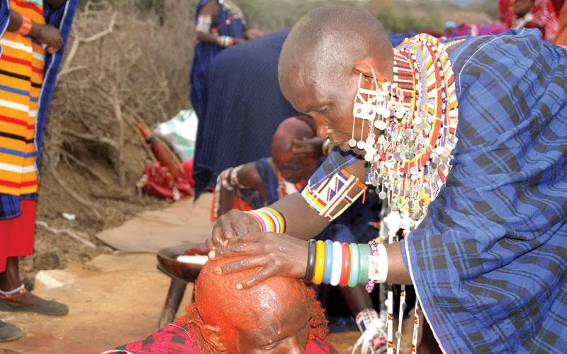 the cutting of a warrior’s long ochre-coated hair