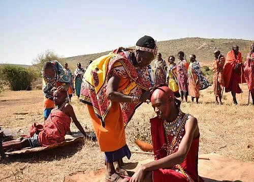 the cutting of a warrior’s long ochre-coated hair