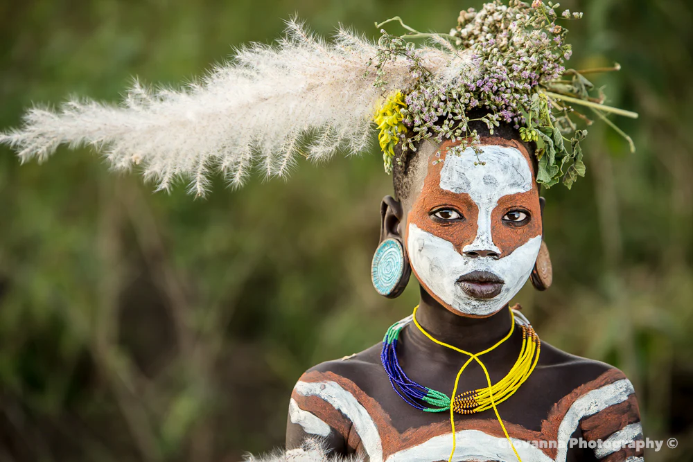 Suri woman displays traditional face painting and handmade adornments