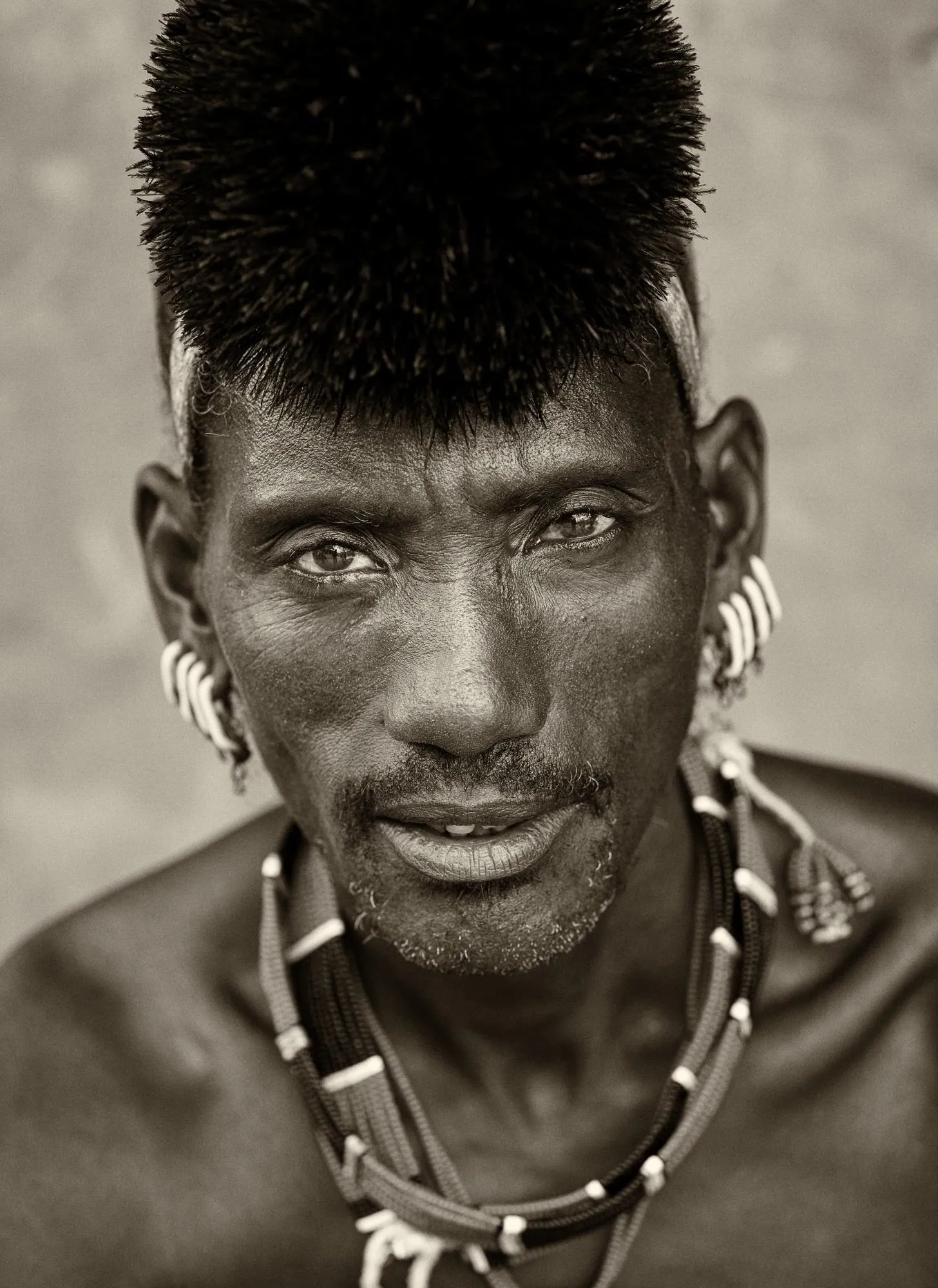 Traditional Hamar man wearing ochre-styled hair