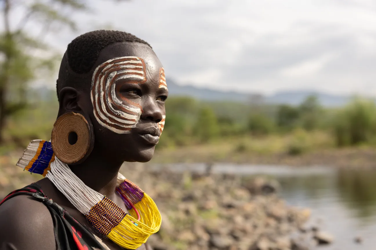 Suri woman displays traditional face painting and handmade adornments