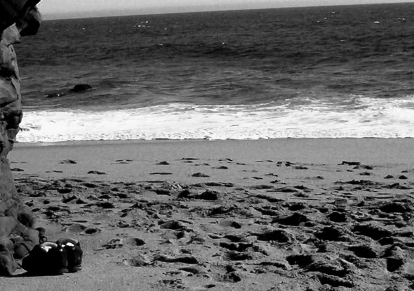 shoes on ocean's doorstep