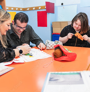ETHIRA's Independent Living workshop, therapist guiding NDIS participants in knitting and art activities