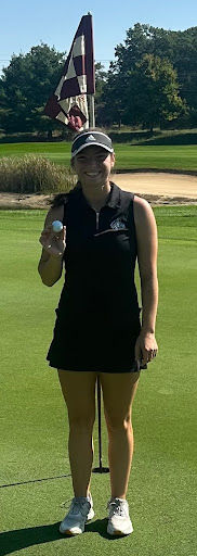 Rochester’s Olivia Bailey shows off the ball after making a hole-in-one on the 17th hole at the Lake Central regional at Sandy Pines Golf Club in DeMotte Saturday. Bailey won medalist honors with a 67.