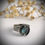 Thumbnail: Nature-inspired silver ring with blue chalcedony gemstone photographed on rustic wooden surface.