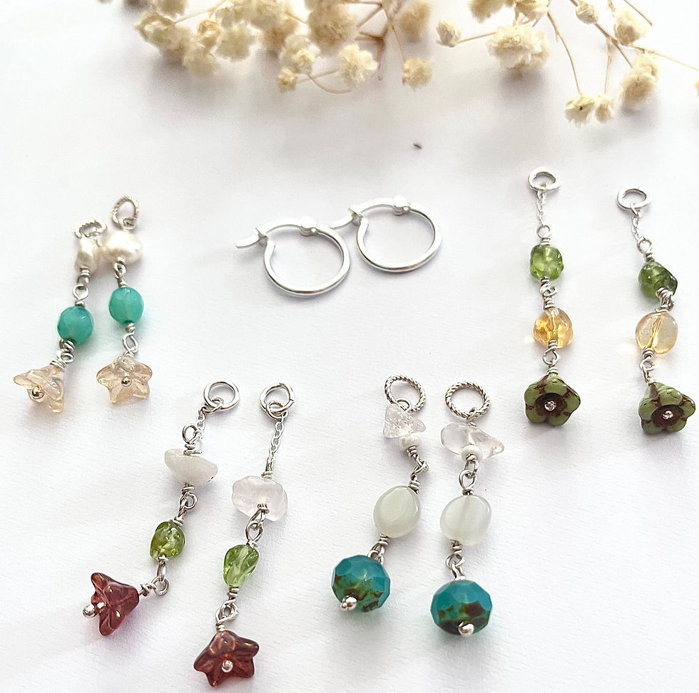 Collection of handmade sterling silver interchangeable gemstone hoop earrings inspired by wildflowers and coastal nature