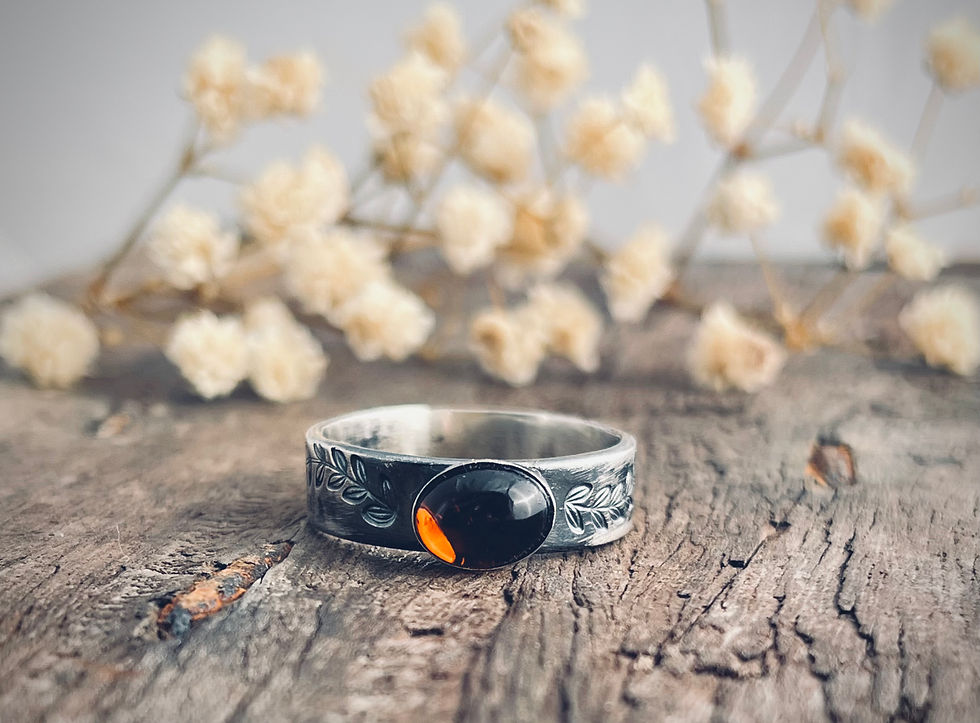 Handmade sterling silver ring with blue chalcedony gemstone set in an organic sculptural design on rustic wood background.