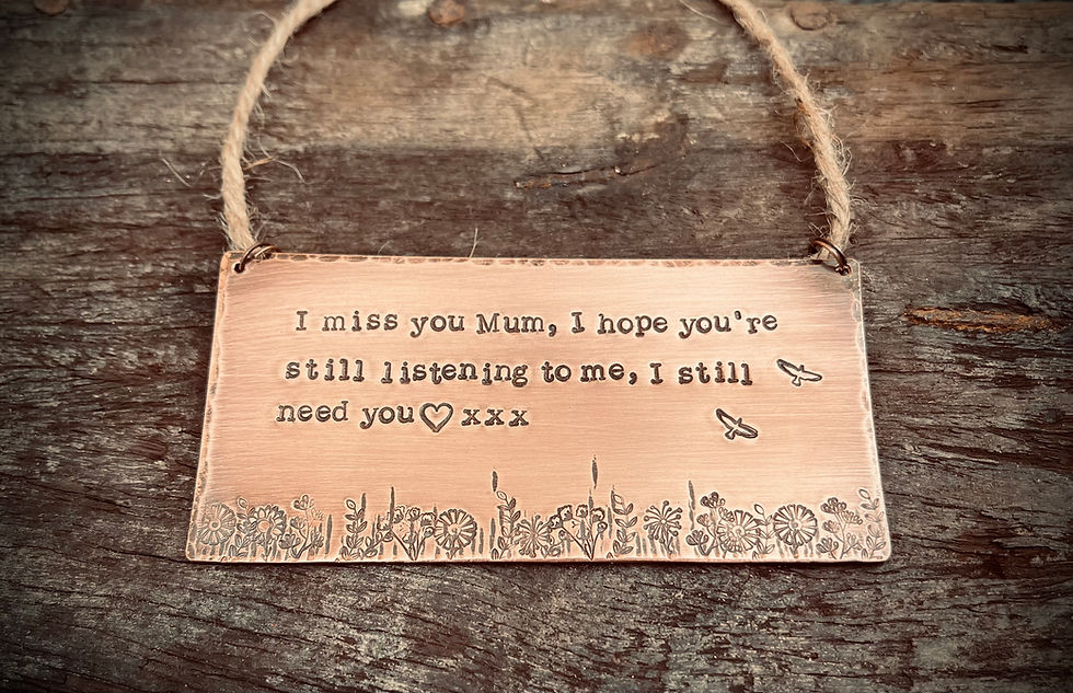 Hand stamped copper remembrance plaque with personalised message hanging on rustic wood background